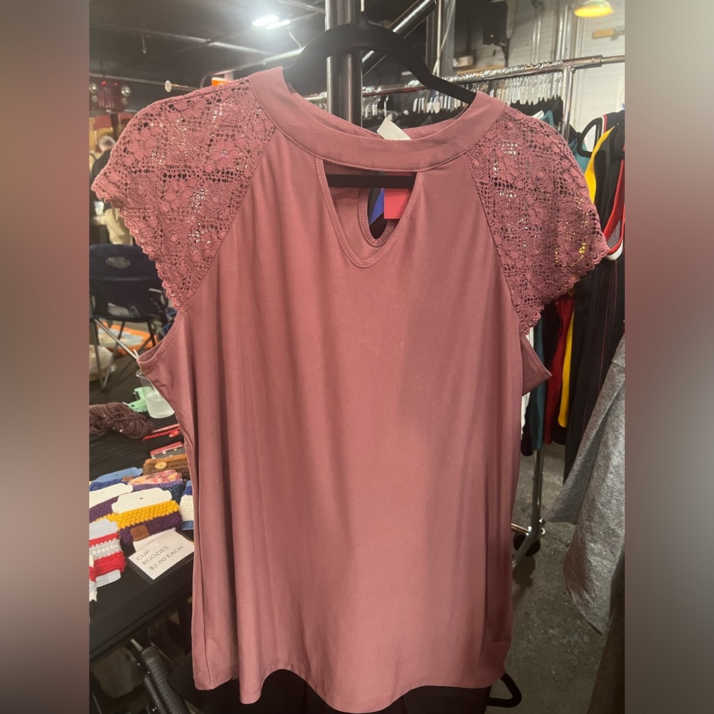 Purple short sleeved top. Silky feel. Buttons on the back of collar.